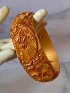 Gorgeous intricately carved and pierced Butterscotch Bakelite Bracelet. Features a carved leaf/foliate pattern and complimentary piercing The bracelet is in very good vintage condition, sold as found. Incredible statement set, true vintage. Standard 2.5 inch opening. One Inch wide width. You will not be disappointed with this beauty, it can hold its own or show up in a Stack! Please contact me if you have specific additional photo requests as photos are part of the description. All items are shi Carved Round Bangle For Formal Events, Carved Round Bangle For Formal Occasions, Unique Carved Bracelet Jewelry, Carved Bangle Jewelry For Formal Occasions, Antique Carved Bangle For Formal Occasions, Formal Carved Bangle Jewelry, Unique Carved Bangle Jewelry, Ornate Carved Wedding Bracelet, Carved Formal Bangle