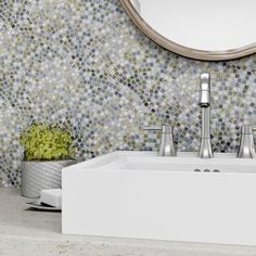 a white sink sitting under a round mirror next to a wall mounted faucet