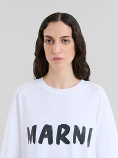 Short-sleeved t-shirt with Marni logo. Crewneck. Boxy fit. Placed Marni logo print on the front. Oversized Logo Tops, Oversized White Tops With Logo Detail, White Oversized Top With Logo Detail, White Oversized Top With Logo, Oversized White Top With Logo Lettering, Oversized White Tops With Logo Lettering, Modern Crew Neck Top With Logo, Casual Tops With Logo Lettering, Tshirt Logo