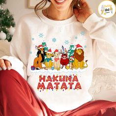 a woman wearing a white shirt with the words hakuna matata on it