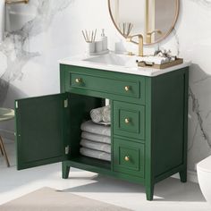 a bathroom with marble walls and green cabinets