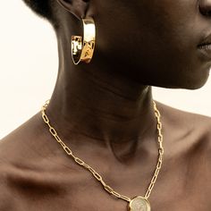 A fresh take on gold hoops: bold, yet sleek. The Maji Hoops are grounding and will have you feeling your most confident. With a handcrafted hammered effect, these earrings were responsibly made by our artisan partners in Kenya using traditional techniques in 24K gold-plated brass. Dimensions: Internal Diameter: 1.65in (42mm)Width of the hoop: 0.39in (10mm) Modern Gold Hammered Hoop Earrings, Modern Hammered Huggie Jewelry, Everyday Hammered Hoop Huggie Earrings, Hammered Hoop Jewelry In Recycled Gold, Hammered Gold-plated Hoop Jewelry, Hammered Gold Plated Hoop Jewelry, Gold Hammered Hoop Earrings In Recycled Gold, Hammered Gold Hoop Earrings In Recycled Gold, Hammered Gold-plated Small Hoop Earrings