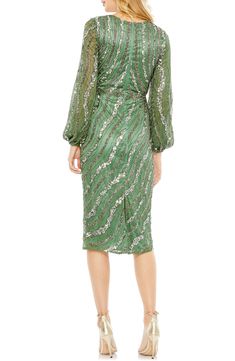 Swirls of sequins animate this elegant cocktail dress, rendered in a verdant hue and styled with a gracefully draped bodice. Surplice V-neck Long sleeves Lined, except sleeves 100% polyester Spot clean Imported Asian Owned/Founded Green Ruched Dress For Gala, Green Ruched Evening Dress For Party, Festive Ruched Dresses For Party, Elegant Green Ruched Evening Dress, Green Ruched Dress For Party Season, Green Draped Evening Dress, Elegant Ruched Sequin Evening Dress, Festive Sequined Midi Evening Dress, Festive Evening Midi Dress With Sequins