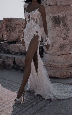 a woman in a white wedding dress posing for the camera with her legs spread out