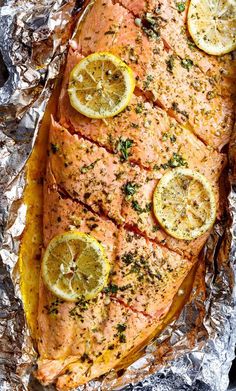 baked salmon with lemons and herbs on foil