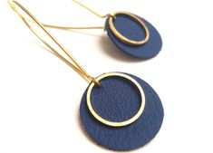 two pairs of blue leather earrings with gold hoops on the end of each ear