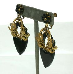 For Sale on 1stDibs - Large and attractive Miriam Haskell Victorian Revival Jet Earrings in signature Russian gilt finish. Gilt filigrees are mounted on black resin drops with Miriam Haskell Earrings, Victorian Revival, Miriam Haskell, Black Resin, Ring Holder, Dangle Earrings, For Sale, Black