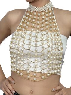 This pearl top is a striking and elegant statement piece designed to elevate any outfit with its luxurious and intricate detailing. The top features a delicate halter-neck design adorned with multiple layers of gleaming faux pearls intricately connected by gold-toned chains, creating a webbed, grid-like structure across the front. The high neckline, fully encrusted with pearls, adds a touch of sophistication, while the cascading pearls arranged in horizontal rows enhance the regal aesthetic. The Elegant Sleeveless Crop Top For Wedding, Elegant Fitted Crop Top For Festive Occasions, Elegant Embellished Wedding Crop Top, Elegant Festive Evening Crop Top, Elegant White Party Crop Top, Elegant White Crop Top For Party, Elegant Festive Crop Top For Wedding, Elegant White Crop Top For Wedding, Fitted Elegant Crop Top For Festivals