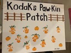 a sign that says kodak's paw -kin patch with pumpkins painted on it