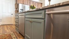 a kitchen with gray cabinets and wood flooring is pictured in this image from the front view