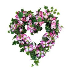 a heart shaped wreath with pink flowers and green leaves