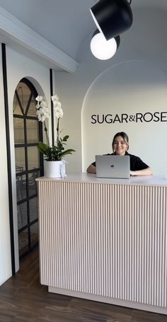 the front desk of sugar & rose is clean and ready for customers to use it