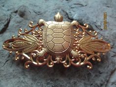 "Beautifully unique handmade barrette. The turtle is made of raw brass, as always lead and nickel free. The barrettes are gold filigree, 3\" wide. (lead and nickel free), very pretty and quite unique. Please do visit my shop, I make gorgeous cameo lockets, necklaces, earrings, chokers, cuff links, matching sets, coin jewelry, and so much more. Please do feel free to message me with custom orders and I will discount larger orders. Thanks so much for lookingLisa" Handmade Brass Gold Brooches, Handmade Gold Brass Brooches, Artisan Gold Brooches For Gifts, Handmade Bohemian Gold Brooches, Bohemian Gold Brooches For Gifts, Bohemian Handmade Gold Brooches, Vacation Cruise, Coin Jewelry, Gold Filigree