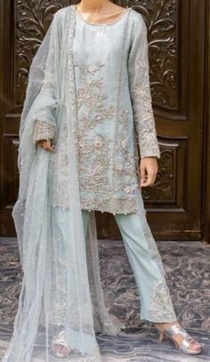 A powder blue hand embellished organza shirt encompasses detailed embroidery on borders is a show stopper. It comes with classy raw silk straight pants and beautifully scalloped net dupatta with heavy embellished border on two sides and light borders on the other two Color: Blue Includes: Shirt Duppata Straight Pants Light Blue Unstitched Suit For Wedding And Eid, Light Blue Unstitched Wedding Suit For Eid, Traditional Light Blue Lawn Suit For Wedding, Unstitched Light Blue Lawn Suit For Wedding, Elegant Designer Light Blue Salwar Kameez, Elegant Light Blue Sets With Dabka Work, Wedding Light Blue Unstitched Suit With Dupatta, Light Blue Salwar Kameez With Sheer Dupatta For Wedding, Elegant Light Blue Salwar Kameez For Festive Occasions