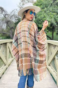 100% Acrylic; Add a vibrant touch to your wardrobe with our boho chevron print, open ruana-- finished with chic fringe detailing along the hem for a Bohemian vibe. It has a relaxed, flowing fit that flatters all body types, and no matter how you style this one babe, it's a Win! Bohemian Woven Poncho For Fall, Fall Bohemian Woven Poncho, Multicolor Bohemian Poncho For Fall, Bohemian Multicolor Poncho For Fall, Spring Poncho With Tassels, One Size Spring Poncho With Tassels, One Size Tassel Poncho For Spring, Spring Poncho With Tassels One Size, Spring Poncho One Size With Tassels