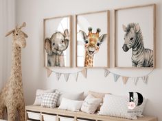 three framed pictures hang on the wall above a bench in a child's room