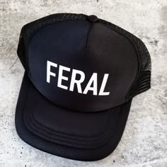 Let your FERAL little one rock their true colors in style for school and weekend outings with the fam. Match your big and littles and let them rock out together. This is a simple white on black black on black classic trucker hat in a kids size (3-8 yo) with the word FERAL in simple block letters. The hat circumference measures 53 cm/20.9 inches. You can change feral to any word of your choice or a name by selecting "Custom Text" and typing it in the personalization box. Funny Trucker Hats, Custom Trucker Hats, Toddler Humor, Funny Hats, Block Lettering, New Product, Trucker Hat