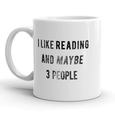 a white coffee mug that says i like reading and maybe 3 people