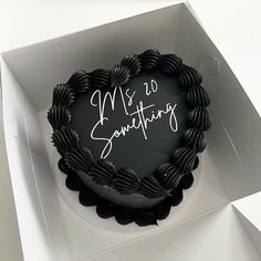 a heart shaped cake in a box with writing on it