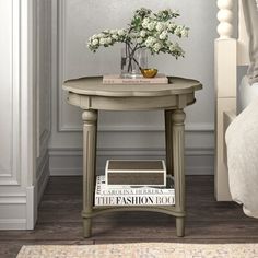 a small table with flowers and magazines on it