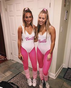 two women in pink and white bodysuits standing next to each other