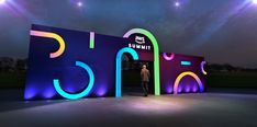 a man standing in front of an illuminated sign