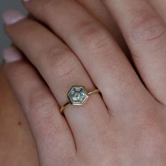 a close up of a person's hand with a ring on it