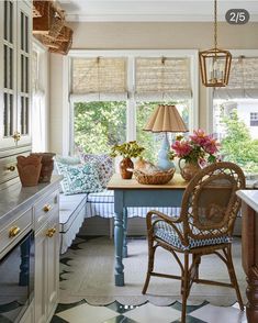 a kitchen with an island, table and chairs next to a window in the room