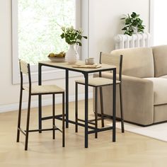 a living room with a couch, table and two stools next to a window