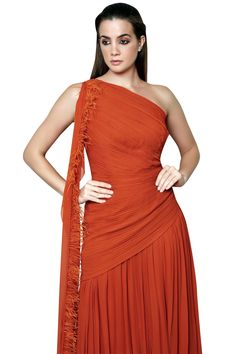 Orange one shoulder gown with pleats and side drape.
Components: 1
Fabric: Georgette
Neckline: Asymmetrical
Sleeve Length: Asymmetrical
Color: Orange
Side drape with fringe detail
Closure: Side zip - Aza Fashions Gown For Women, One Shoulder Gown, Ladies Gown, Gowns Online, Aza Fashion, Color Orange, Side Zip, One Shoulder Formal Dress, One Shoulder