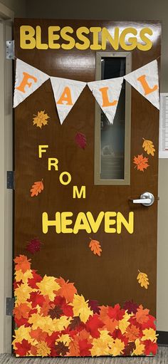 a door decorated with autumn leaves and the words blessing fall from heaven