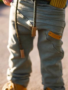 a close up of a person's legs wearing yellow shoes and holding a cell phone