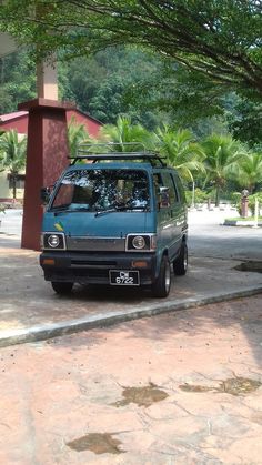 a blue van parked on the side of a road