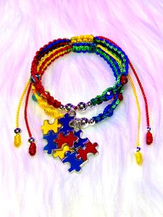 multicolored bracelets with colorful beads and charms on white furnishe background