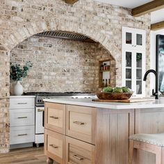 a kitchen with an oven, counter and stools