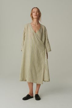 We have you covered with this styling staple wrap dress called Junko. Designed with functionality and comfort in mind, this linen dress features a deep V-neckline, long sleeves, dropped shoulders, and an extra oversized fit. Wrap-front details are ideal for dressing up or down to suit your plans. SIZING AND FIT This garment is oversized. If you want to wear this piece as close-fitting, select a smaller size than you usually wear. Before placing an order, check the approximate measurements of the Striped Linen Dresses For Vacation, Striped Linen Beach Dress, Striped Linen Dress For The Beach, Chic Striped Linen Dress, Chic Relaxed Fit Striped Dresses, Linen Dress Summer, Linen Wrap Dress, Dress Maternity, Natural Linen Fabric