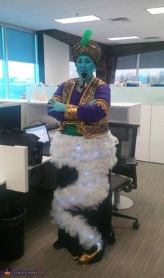 a man dressed in costume standing next to an office cubicle