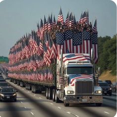 a large truck with american flags on it's back drives down the highway in traffic