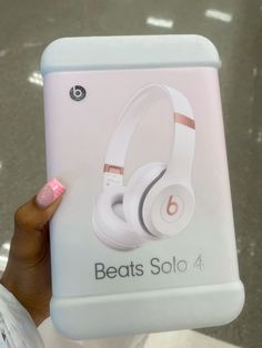 the beats solo 4 wireless headphones are being held up