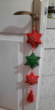 three red and green stars hanging from a door handle