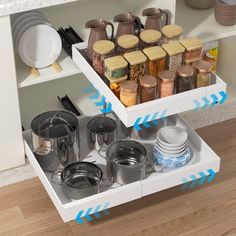 an open drawer with pots and pans on it