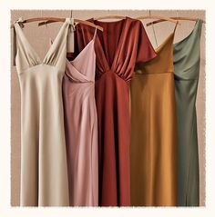 four different dresses hanging on a clothes rack