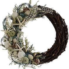 a wreath with white flowers and branches on it is shown in front of a white background