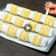 a person is placing slices of food on a tray