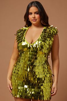 a woman wearing a gold sequin dress