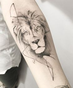 a black and white photo of a lion's head on the left arm with an arrow in it