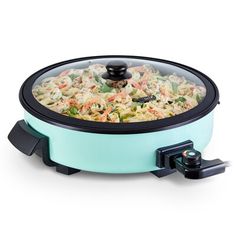 an electric food cooker is shown with the lid open to show pasta and vegetables