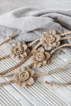 three pieces of burlocked fabric with flowers on them sitting on a table