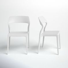 two white chairs sitting next to each other in front of a white wall and floor