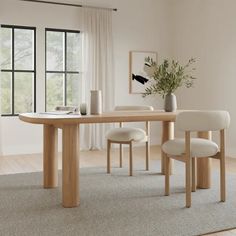 a dining room table with two chairs and a vase on the floor next to it